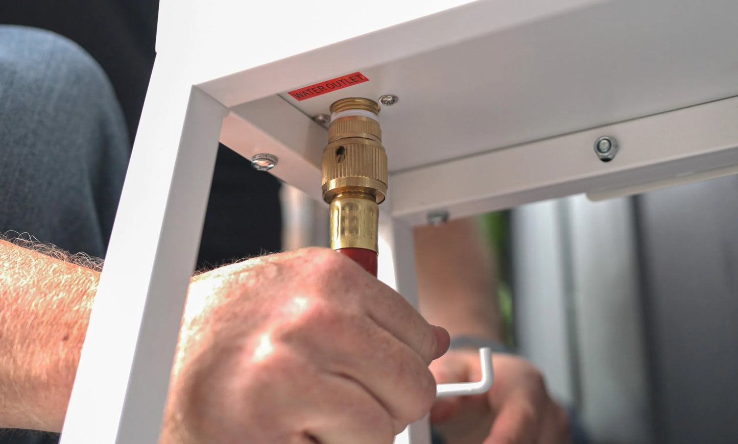 Connecting red hose to water outlet