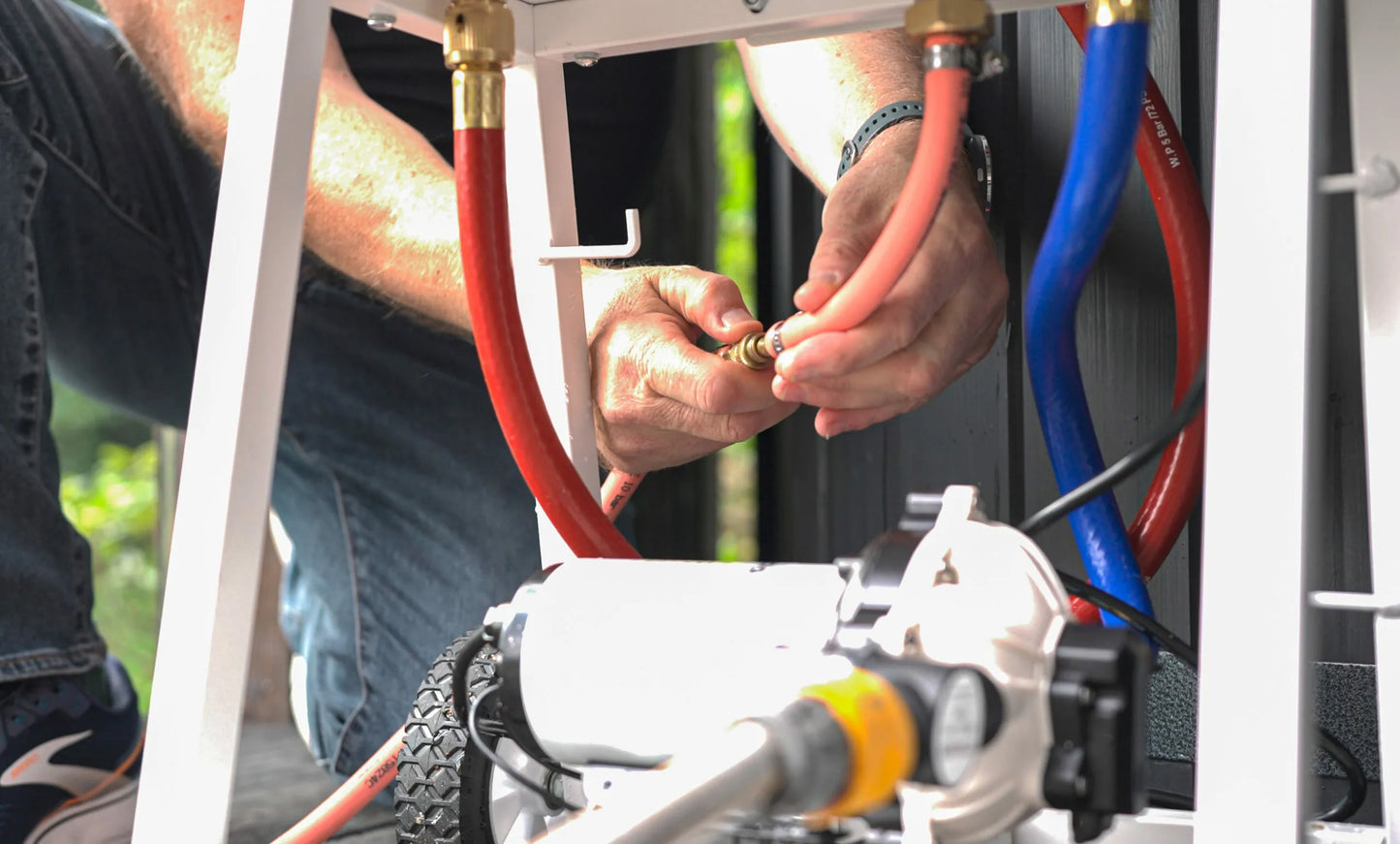 White structure with brackets and hoses