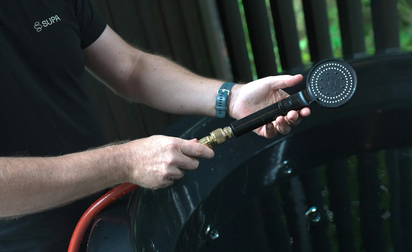 Person with portable shower head